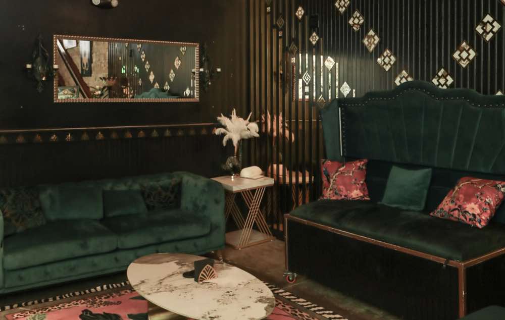 The emerald velvet lounge with art deco mirror panels